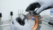 © Elvira - Hands wearing textured technical gloves precisely assembling a complex high performance motor rotor in a clinical lab