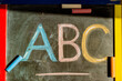 © Iliya Mitsk - Colorful ABC letters written in chalk on classroom blackboard