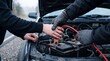 © Aurora Aesthetics - car battery jump start roadside assistance friends teamwork vehicle emergency Two people connect jumper leads under an open hood solving a breakdown for automotive repair and service campaigns