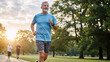 © D-point - Happy man jogging in park in morning light. Healthy lifestyle for senior people, active recreation outdoor, fitness, and vitality concept.