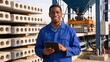 © JohnLee - Smiling African engineer with tablet at a modern precast cement factory under natural daylight.