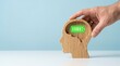 © GRAPHIC - Wooden head with battery icon for mental health. Concept of recharging human energy levels.