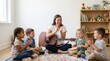 © Ally_art - Kindergarten teacher clapping with group of diverse children playing music in classroom. Girl and boy singing song with tutor in preschool. Early childhood education and development.