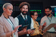© Zamrznuti tonovi - Diverse team of it specialists collaborating in a server room, managing network infrastructure and cloud computing operations
