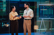 © Zamrznuti tonovi - It professionals discussing data center infrastructure and network security in a modern server room