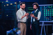© Zamrznuti tonovi - It technicians discussing network security and data management, collaborating on solutions in a modern data center