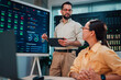 © Zamrznuti tonovi - It professional discussing server room data management and monitoring with female colleague in data center