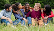 © Vittorio Gravino - Group of Diverse Friends Embracing and Laughing in Grass Field