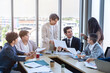 © Thinapob - Successful happy workers Group of business people with Multiethnic workers with in company workers Group of asian business people and support Teamwork in the meeting room at modern office.