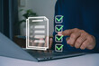© MUNTHITA - Businessman using laptop for online checklist survey, filling out digital form checklist. take assessment, questionnaire, evaluation, online survey, online exam. Business performance checklist concept