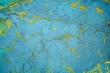 © IRAIDA - abstract texture of liquid acrylic paint in blue colors with splashes of gold pigment