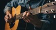 © fitri - Close-up of a person playing an acoustic guitar with focus on hands and strings.
