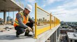 © OlgaNeuroArt - Construction worker installing a yellow safety railing with a power drill. Builder securing edge protection on a high-rise building site