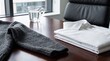 © Budsakorn - Neat folded white shirt and knit sweater on a desk office