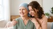 © NurAini - Caring daughter embraces her senior mother wearing a blue headscarf during cancer treatment at home, both women sharing a moment of hope and love while looking forward to a very bright future