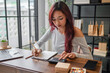 © Charlie's - Woman managing small business accounts and recording sales revenue and expenses business income financial management entrepreneurship .