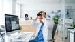 © akridiy - Overwhelmed medical specialist holding head in hospital office