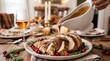 © Itachi - Gravy being poured over carved roasted turkey with cranberries and rosemary on festive holiday table setting.