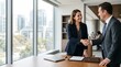 © Felippe Lopes - Business professionals shaking hands in a modern office with city view
