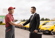 © Ljupco Smokovski - Businessman shaking hands with a delivery courier worker
