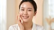 © R.Fauzi - Beautiful Young Asian Woman with Radiant Complexion Smiling and Touching Her Cheek in Bright Interior