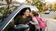 © shiper - Mother dropping daughter off at school. Child kissing mom goodbye before morning class.