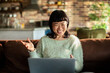 © Davor - Smiling woman on video call at home
