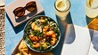 © fivan - A casual summer lunch scene featuring grilled peach salad beside sunglasses, a notebook, and lemonade