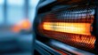 © Dhea - Glowing orange heat element behind a protective metal grill