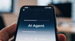 © scaliger - AI Agent text on a smartphone screen. Person holding a mobile phone with an artificial intelligence application