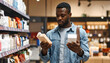 © Monmeo - Choosing products: A man in a retail store carefully examines two items, comparing them before making a purchase decision.