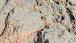 © Maule - Close up view of rough volcanic rock texture with porous surface and natural crevices, ideal for stone background, geology, and abstract surface design.