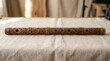 © Darul - carved wooden flute on table