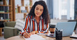 © peopleimages.com - Writing, paperwork and woman in home for remote work, finance review and budget planning. Wfh, accounting and person with documents, laptop and financial report for revenue, portfolio and audit