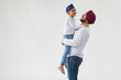 © IndiaPix - A SIKH FATHER RAISING HIS SON ABOVE AND SPENDING TIME TOGETHER
