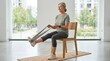 © Alva - Senior woman exercising with a resistance band while sitting on a wooden chair in a bright studio.