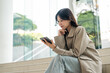© Chanakon - Cheerful young Asian businesswoman using digital tablet flexible working life balance in green urban park, modern lifestyle productivity remote work with digital online technology.