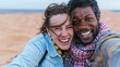 © Breezze - Smiling young couple taking a candid selfie in a vast desert, windswept hair and dusty clothes, for travel and adventure lifestyle content