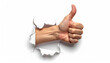 © Fawitra - Close up of a human hand emerging through torn paper, giving a thumbs up gesture of approval and positivity