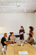 © BONNINSTUDIO/Stocksy - Professionals working together during a business meeting
