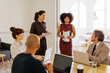 © BONNINSTUDIO/Stocksy - Business professionals working together during a meeting