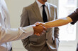 © BONNINSTUDIO/Stocksy - Business colleagues shaking hands making agreement