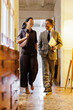 © BONNINSTUDIO/Stocksy - Businesspeople walking hallway discussing business
