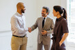 © BONNINSTUDIO/Stocksy - Business professionals shaking hands completing a successful deal