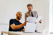 © BONNINSTUDIO/Stocksy - Business associates collaborating on laptop during meeting