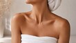 © Ann - Woman Wrapped in Towel After Spa Treatment Close-up of a woman wrapped in white towels, showing smooth skin and shoulders in a relaxing spa and skincare setting.
