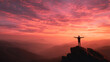 © DP - Silhouette of a person standing on a rocky peak with arms outstretched against a vibrant sunset sky over mountainous landscape in the background