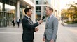 © Usman - Professional Business Interview Outdoors: Male Reporter in Dark Suit Holding Microphone Interviewing Corporate Executive in Light Grey Suit Outside Modern Glass Office Building at Golden Hour Sunset