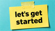 © AI   NEX GEN - Yellow sticky note with let's get started text on blue background