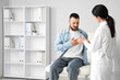 © Pixel-Shot - Doctor examining a man with chest pain using a stethoscope in a medical office for health checkup and diagnosis